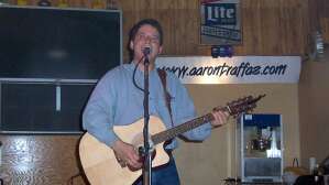 Aaron Traffas singing with an acoustic guitar at Mike's Sports Bar in Medicine Lodge, in south-central Kansas