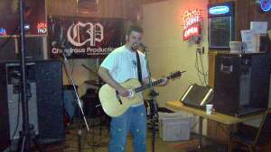 Aaron Traffas singing with an acoustic guitar at Mike's Sports Bar in Medicine Lodge, in south-central Kansas