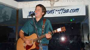 Aaron Traffas singing with an acoustic guitar at Buster's Saloon in Sun City, in south-central Kansas