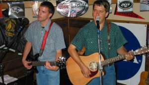 Aaron and Jim performing with acoustic guitars at Route 40 in Victoria, Kansas
