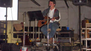 Aaron Traffas singing with an acoustic guitar at private party in Manhattan, in northeast Kansas