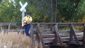 Aaron Traffas singing with an acoustic guitar at a private party in Medicine Lodge, in south-central Kansas