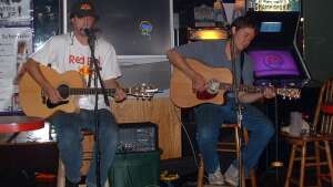 Aaron Traffas and Trevor Burgess performing with acoustic guitars at JC's Bar and Grill in Salina, in central Kansas