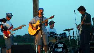 Trevor Burgess performing with acoustic guitar at Gyp Hills Trail Ride in Medicine Lodge, in south-central Kansas