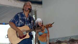 Aaron Traffas singing with an acoustic guitar at Buster's Saloon in Sun City, in south-central Kansas