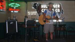 Trevor Burgess singing with an acoustic guitar at Copper Penny in Stillwater, in northeast Oklahoma