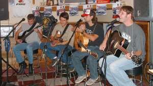 Four acoustic guitarists performing at Route 40 in Victoria, Kansas