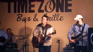 Pearl Grey performing with acoustic guitar at Time Zone Bar & Grille in Lenora, in northwest Kansas