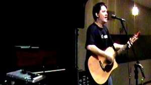Aaron Traffas singing with an acoustic guitar at VIP Supper Club in Alva, in north-central Oklahoma