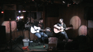 Aaron Traffas and Trevor Burgess performing with acoustic guitars at Bobby T's Bar and Grill in Manhattan, in northeast Kansas