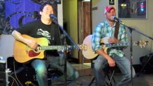 Aaron Traffas and Anthony Farrar performing with acoustic guitars at Buster's Saloon in Sun City, in south-central Kansas