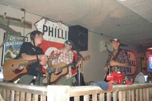 Aaron Traffas, Anthony Farrar, and Lucas Maddy performing at Blue Goose in Sharon, in south-central Kansas