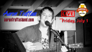 Aaron Traffas singing with an acoustic guitar at Finnegan's Bar and Grill in Medicine Lodge, in south-central Kansas