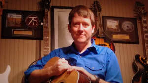 Aaron Traffas with acoustic guitar at Dovie's Bar in Kiowa, in south-central Kansas