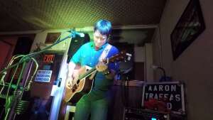 Aaron Traffas singing with an acoustic guitar at Dovie's Bar in Kiowa, in south-central Kansas