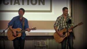 Aaron Traffas and Lucas Maddy performing with acoustic guitars at KLA in Manhattan, in northeast Kansas