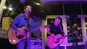 Aaron Traffas and Lucas Maddy performing with acoustic guitars at Repeal 18th in Kansas City, in northwest Missouri