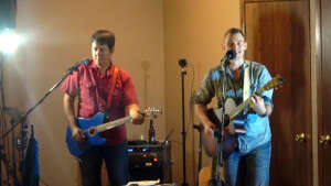 Aaron Traffas and Lucas Maddy performing with guitars at Oakley Country Club in Oakley, in northwest Kansas