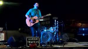 Aaron Traffas performing with acoustic guitar at Coldwater Street Dance in Coldwater, in south-central Kansas