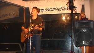 Aaron Traffas singing with an acoustic guitar at Buster's Saloon in Sun City, in south-central Kansas