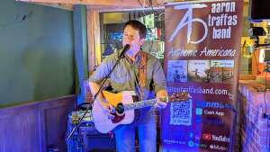 Aaron Traffas singing with an acoustic guitar at Idle Hour in Anthony, in south-central Kansas