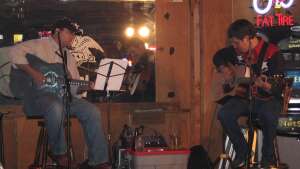 Aaron Traffas and Robert Hildreth performing with acoustic guitars at Bobby T's Bar and Grill in Manhattan, in northeast Kansas