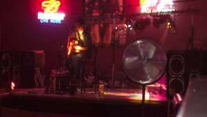 Aaron Traffas singing with acoustic guitar at Donny G's in Dodge City, in southwest Kansas