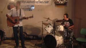Aaron Traffas singing with acoustic guitar at Ira's in Alva, in north-central Oklahoma