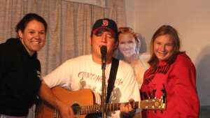 Aaron Traffas singing with an acoustic guitar at Buster's Saloon in Sun City, in south-central Kansas