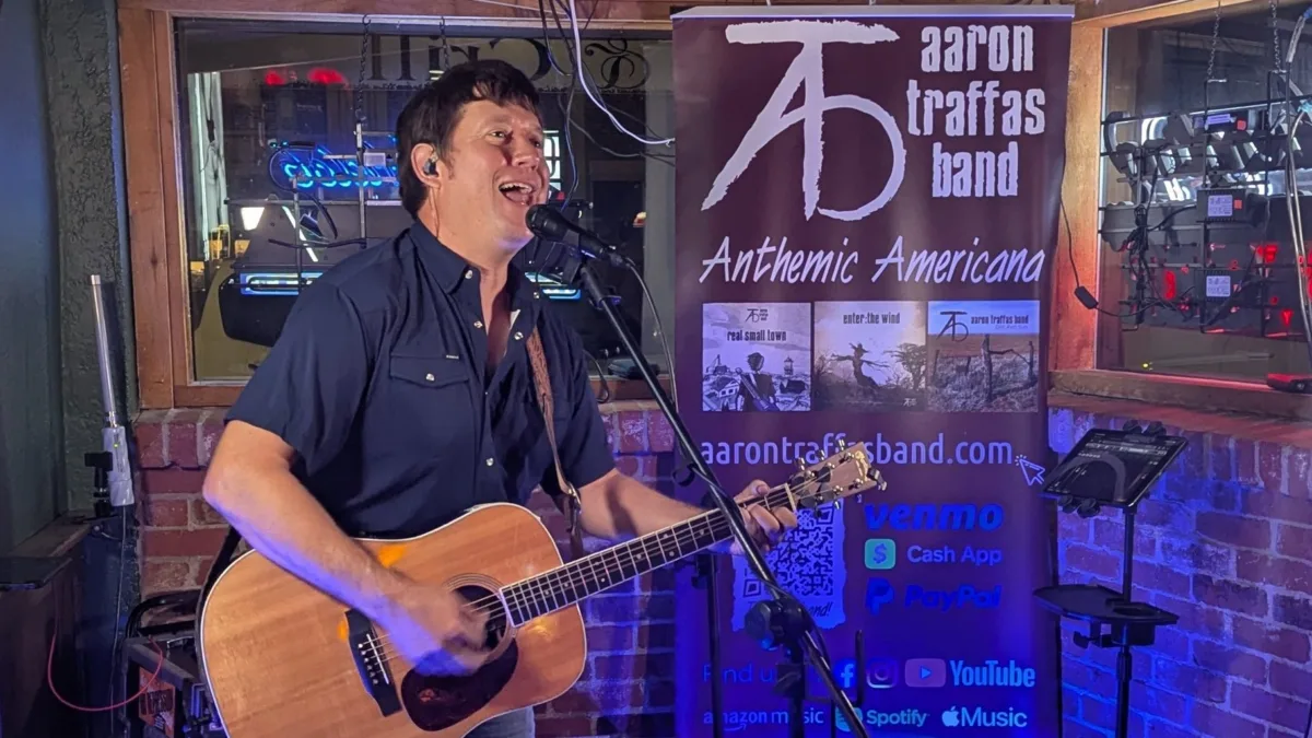 Aaron Traffas singing with an acoustic guitar at Idle Hour in Anthony, in south-central Kansas