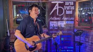 Aaron Traffas singing with an acoustic guitar at Idle Hour in Anthony, in south-central Kansas