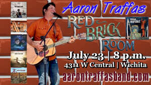 Aaron Traffas singing with acoustic guitar at Red Brick Room in Wichita, in south-central Kansas